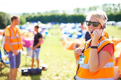 Buy stock photo Festival security, communication and a woman outdoor on a grass field for safety at a music concert. Party, event and crowd control with a female officer using a headset microphone for protection