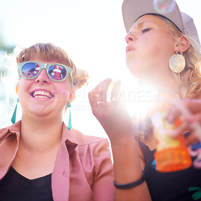 Buy stock photo Smile, friends and women blowing bubbles outdoor in nature, play fun game at festival or freedom in summer. Happy young girls with soap at party celebration, hanging out at carnival together or flare