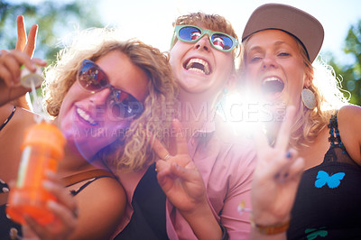 Buy stock photo Portrait, peace sign and funny friends in sunglasses outdoor, blowing bubbles and laughing together in summer. Face, women and group of girls with v hand gesture, excited and lens flare in nature