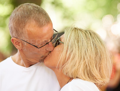 Buy stock photo Love, mature couple and kiss outdoor together, care and healthy relationship, connection or bonding. Lips touch, man and woman in romance, face profile and support, marriage commitment and passion