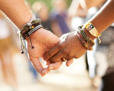 Buy stock photo Cropped closeup view of a multi-ethnic couple holding hands
