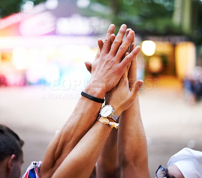 Buy stock photo Cropped shot of a group of friends high-fiving at an outdoor festival
