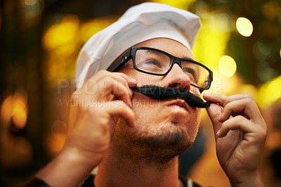 Buy stock photo Man, chef and mustache at outdoor festival in fashion or style with glasses in forest or park. Young male person with fake moustache, spectacles and hat at music concert, event or carnival in nature