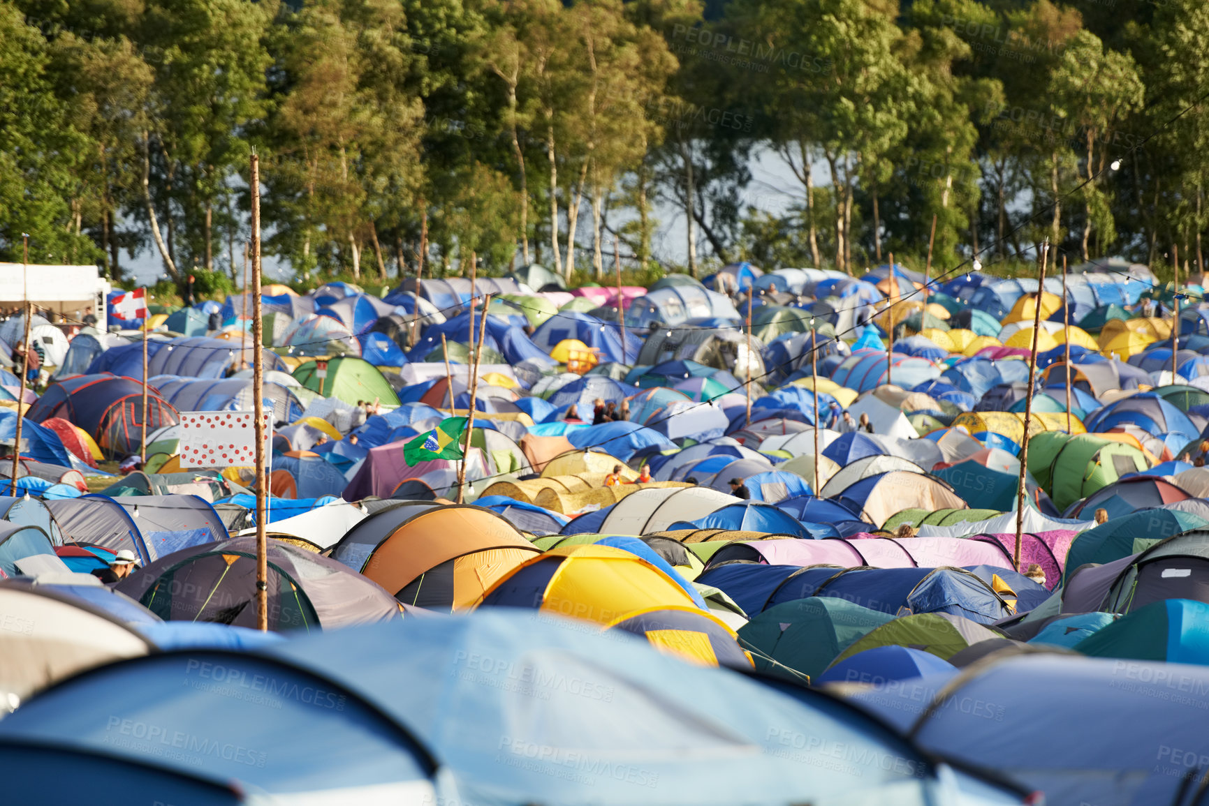 Buy stock photo Camping, tents and outdoor music festival in park, field with trees or forest in summer. Camp, site and shelter at party, event or adventure with travel in woods for concert, rave and carnival