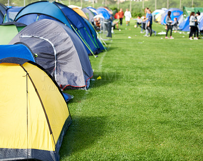 Buy stock photo Music festival, camping and tents in park with people in summer, holiday or field at concert in countryside. Camp, site or adventure shelter on grass in woods or group at carnival in morning of rave