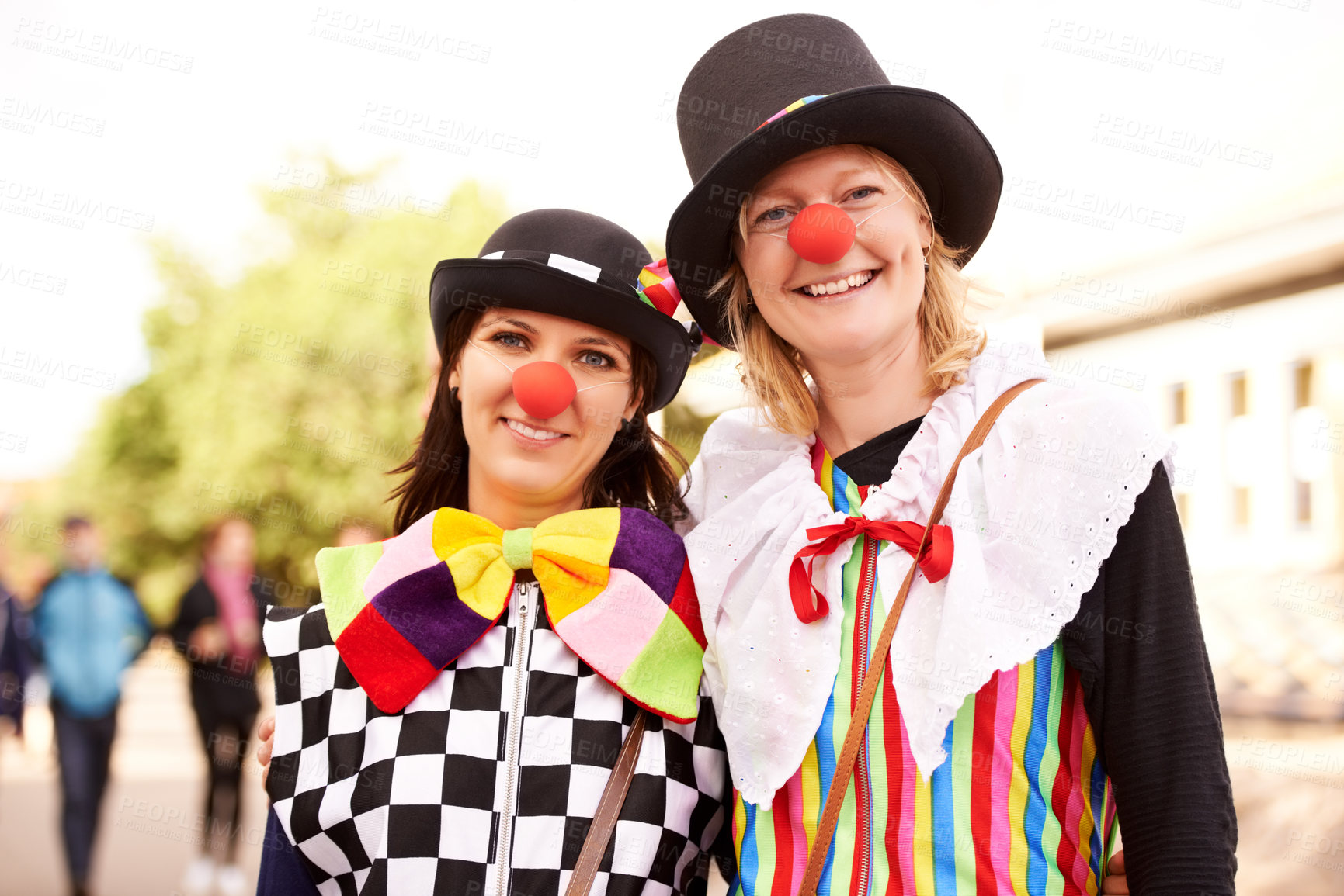 Buy stock photo Clown, people and portrait outdoor at festival, carnival or costume for event or concert in park. Happy, women and smile in funny props, clothes and dress up for culture, party in summer or holiday