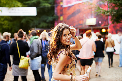 Buy stock photo Music, festival and portrait of woman at a concert, field with crowd and audience or excited fan at event. Happy, girl and walking to stage or dancing with drink at party with alcohol and celebration