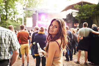 Buy stock photo Woman, portrait and drink at outdoor music festival with crowd for party or event in nature. Face of female person smile and enjoying sound or audio at carnival, concert or performance outside