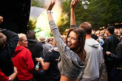 Buy stock photo Happy woman, portrait and crowd in music festival for party, event or DJ concert in nature. Excited female person smile with hands up and audience at carnival, performance or summer fest outside