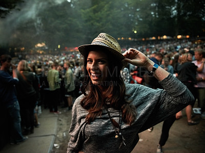 Buy stock photo Excited woman, portrait and night at music festival party, event or outdoor DJ concert. Happy female person smile with hat in evening crowd or audience at carnival, performance or summer fest outside