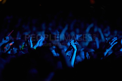 Buy stock photo Concert, hands and audience for music with blue lights, neon and night festival, concert or psychedelic party. Crowd with arms raised with nightlife and rave or techno event for new year holiday