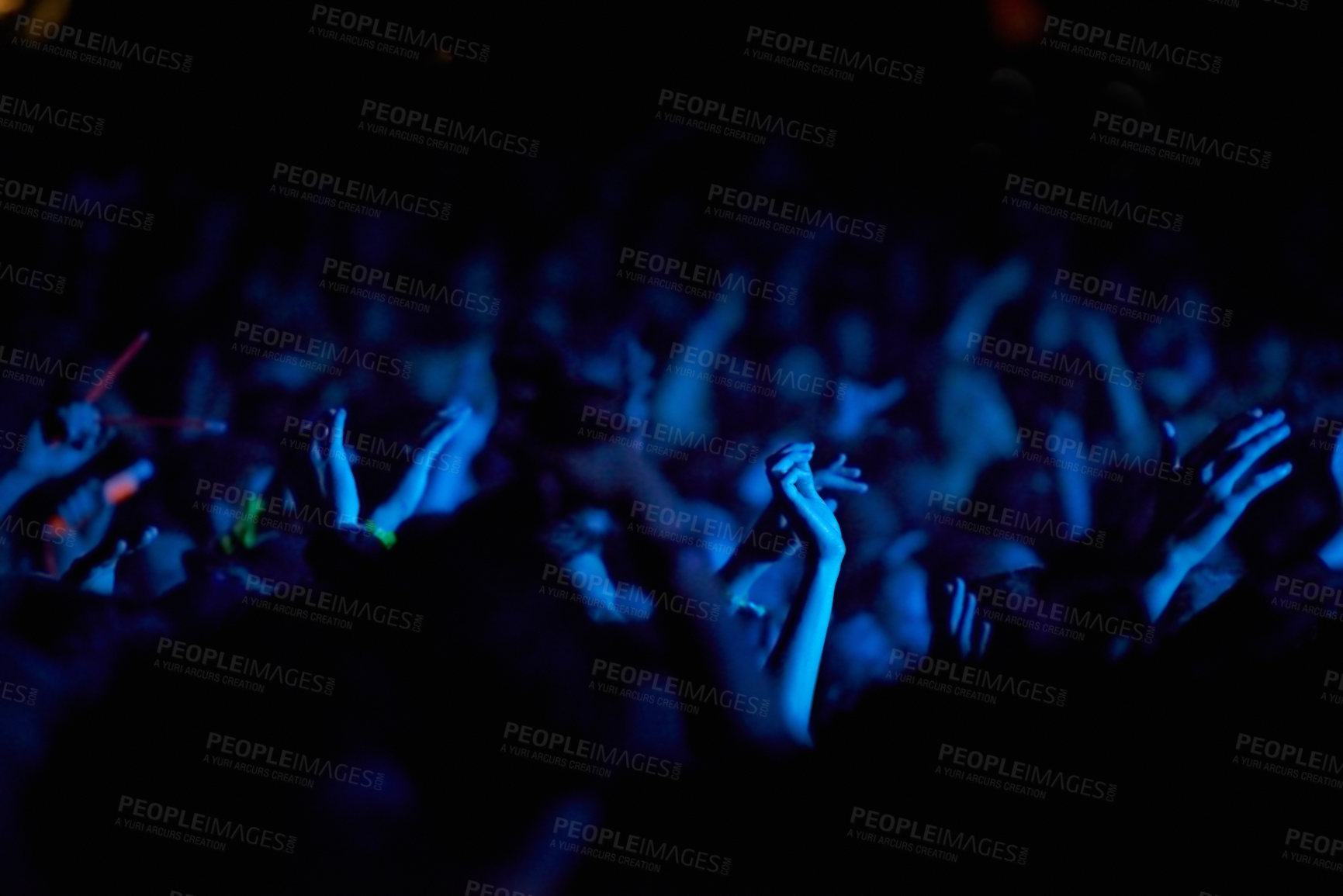 Buy stock photo Concert, hands and audience for music with blue lights, neon and night festival, concert or psychedelic party. Crowd with arms raised with nightlife and rave or techno event for new year holiday