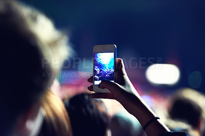Buy stock photo Woman, hand and smartphone for picture at concert with post, social media or recording of show. Closeup, female person and mobile app for sharing on internet for music, event or festival with crowd