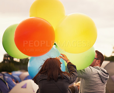 Buy stock photo Music festival, celebration and people with balloons outdoor, camping and playing in woods. Party, man and woman at event with colorful, decoration for camp site and energy at carnival or concert