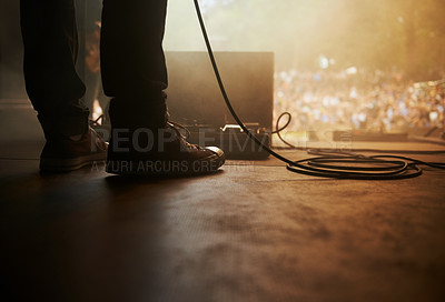 Buy stock photo Cropped shot of a musician's feet on stage at an outdoor music festival