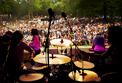 Buy stock photo Band, concert and stage in outdoors, party and event or energy for freedom on vacation. People, drums and music festival or rave, audio and song for fun crowd and musicians with instruments for show