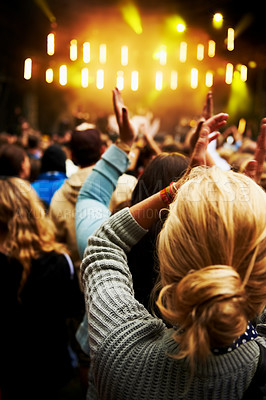 Buy stock photo Rearview shot of a crowd of young people at an outdoor music festival