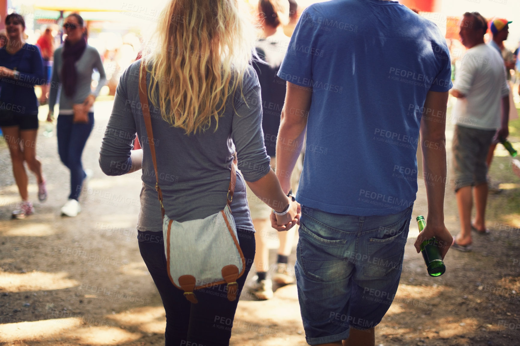 Buy stock photo Back, music festival and holding hands with couple, outdoor and walking with summer, vacation and event. Party, outside and man with woman, marriage and party with concert, love and people with joy