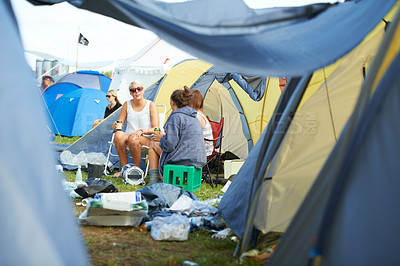 Buy stock photo Camping, tent and friends with drinks at a festival, event or group in conversation with garbage on ground. People, talking and relax with beer at party in summer, vacation or travel on holiday