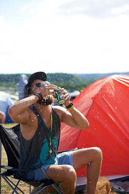 Buy stock photo Man, drinking beer and fun in outdoors, music festival and alcohol and relaxing at party or camp. Male person, wine and crazy in nature, outside and freedom or energy for celebration at social event