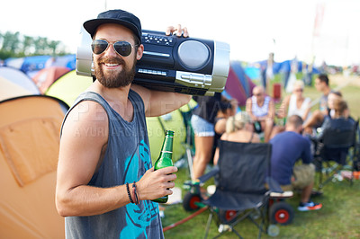 Buy stock photo Shot of a guy carrying a boom-box on his shoulder and drinking a beer at an outdoor music festival