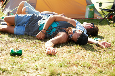 Buy stock photo Sleeping, drunk or friends on field in festival hangover in social celebration, party or concert. Fatigue, grass or tired people with alcohol drinks or can on outdoor music event or holiday vacation 