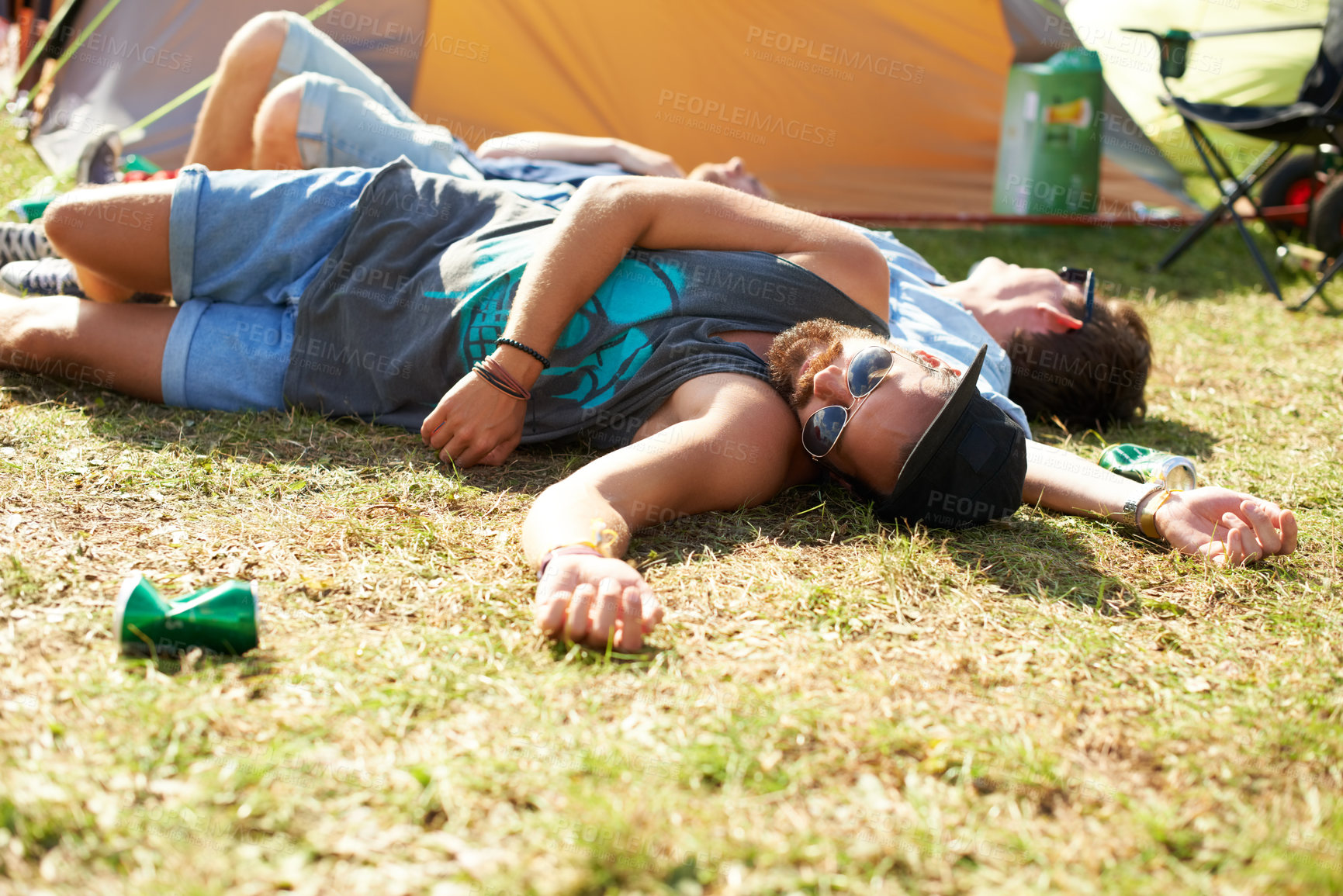 Buy stock photo Sleeping, drunk or friends on field in festival hangover in social celebration, party or concert. Fatigue, grass or tired people with alcohol drinks or can on outdoor music event or holiday vacation 