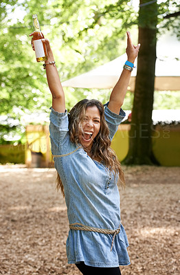 Buy stock photo Portrait, shouting and arms raised with a woman at a music festival, drinking beer in celebration. Freedom, energy and screaming with a young person outdoor at a concert, show or performance