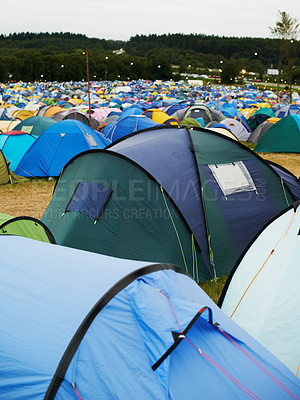 Buy stock photo Tent, field and outdoor for music festival or camping in nature, summer or forest for adventure or vacation. Event, campsite or setup for sleeping, rest or shelter in woods, trees or environment