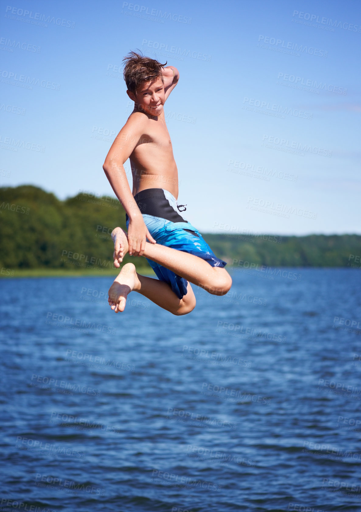 Buy stock photo Portrait, jump and ocean with water, vacation and excited with happiness, weekend break and movement. Person, outdoor and guy with water, cheerful and extreme with nature, seaside and energetic