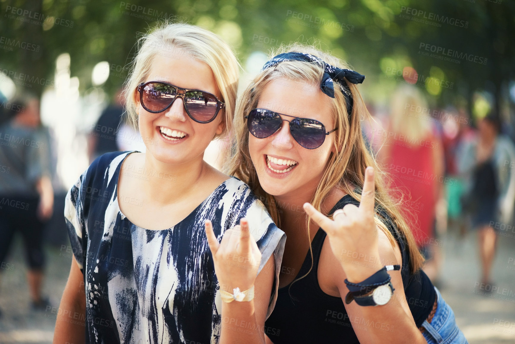 Buy stock photo Portrait, outdoor and women with event, excited and nature with happiness, cheering and cheerful. Face, people and friends with music festival, rock concert and energy with culture, hand sign and joy