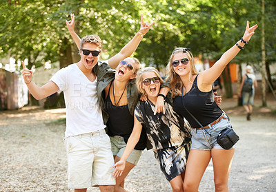 Buy stock photo Celebration, hug and friends at a park for festival, concert or happy social gathering. Face, fun and people in a forest with freedom, energy and excited for event, reunion or party with rocker hands