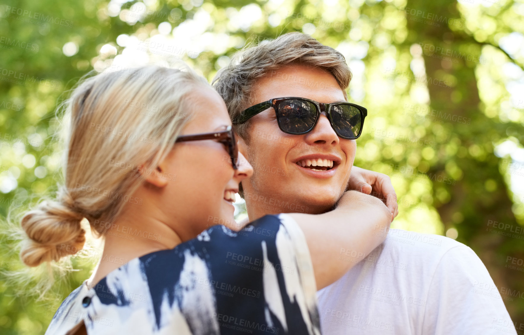 Buy stock photo Love, hug and happy couple in a park with conversation, support and vacation freedom. Travel, care and people embrace in a forest for summer, romance or bond, speaking or adventure in nature together