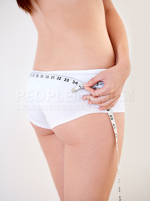 Buy stock photo Hands, body and woman with tape measure on butt in underwear for weight loss, health and wellness isolated on a white studio background. Model, girl and measuring back for diet, care or slim figure