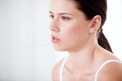 Buy stock photo Closeup of a beautiful young woman looking away thoughtfully
