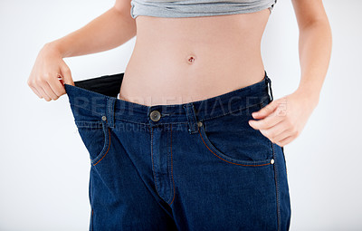 Buy stock photo Weight, loss and woman with change in jeans, size and comparison on white background in studio. Healthy, body and person with large transformation from fitness, diet or show results in denim pants
