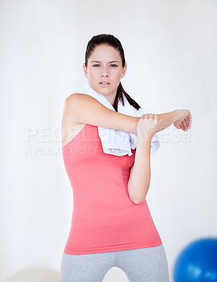 Buy stock photo Athlete stretching, gym or portrait of woman with towel for fitness or wellness with confidence. Serious, model or healthy sports person ready for workout, training arms or exercise warm up in club