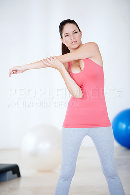 Buy stock photo Stretching arm, portrait or woman in gym with fitness for body flexibility, health or wellness. Serious, athlete or sports person ready for workout, training or exercise warm up for mobility in USA