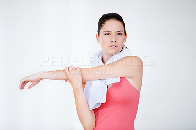 Buy stock photo Stretching arm, thinking or woman in gym with towel for fitness, flexibility or wellness on white background. Serious, athlete or healthy sports person ready for workout, training or exercise warm up