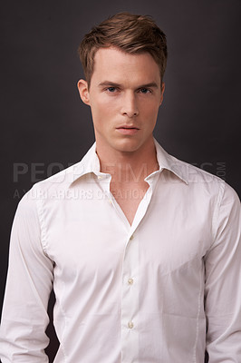 Buy stock photo Portrait, fashion and a masculine young model in studio on a dark background in an open collar shirt. Cool, clothing and style with a confident man in a trendy outfit for the cover of a magazine