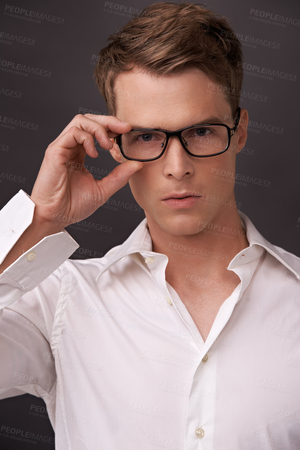 Buy stock photo Serious, nerd and portrait of man with glasses, fashion or eyewear in dark background of studio. Optometry, healthcare and geek with spectacles, style and person with prescription lenses in frame 