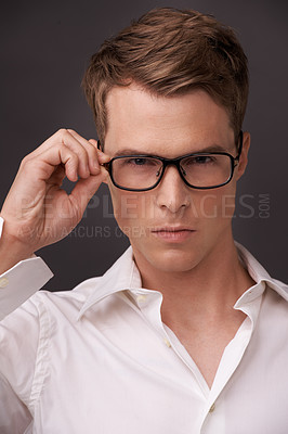 Buy stock photo Serious, man and confident portrait with glasses, fashion or choice in eyewear on dark background of studio. Check, optometry and geek with spectacles, style and person with prescription lenses