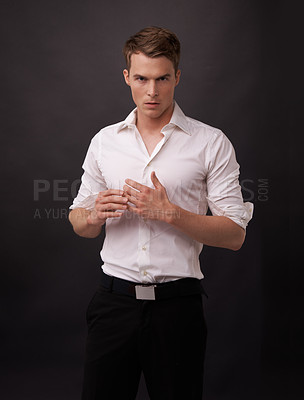 Buy stock photo Portrait of a handsome young man against a black background