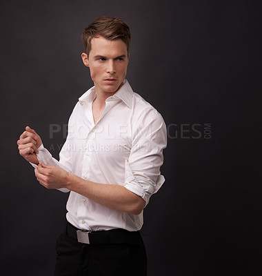 Buy stock photo Fashion, studio man and thinking of fancy clothes for semi formal outfit, attire or confident in classy, elegant or stylish apparel. Fix dress shirt, mockup space or model choice on black background
