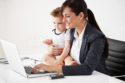 Buy stock photo Remote work, laptop and a mother with care of a baby while working, typing email and doing research. Happy, business and a mom with a computer for entrepreneurship while caring for a child in a house