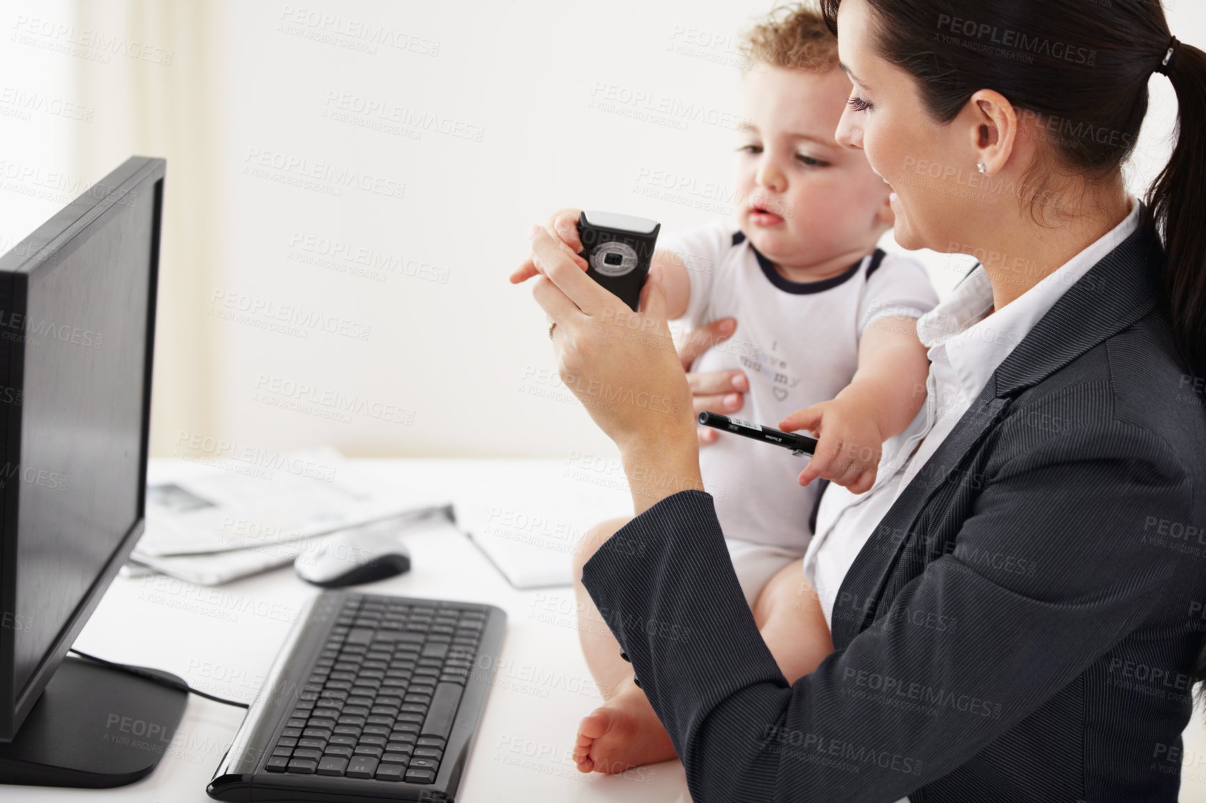 Buy stock photo Woman, home office and phone with baby, computer and care with smile, teaching and multitasking at desk. Happy mother, young kid and cellphone for playing, bond and remote work at pc in family house
