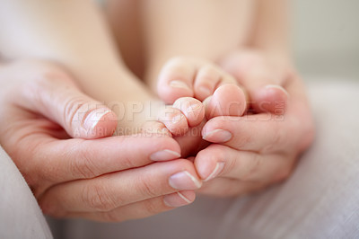Buy stock photo Love, mother and hands with baby or feet for development, nurture and bonding in nursery of apartment. Family, woman or newborn toes with relax, support or care for relationship or motherhood in home