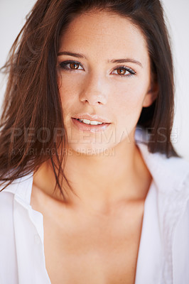 Buy stock photo A stunning young woman wearing only a shirt giving you a smoldering look