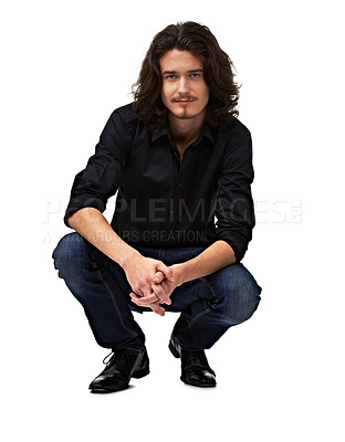 Buy stock photo Young handsome male model crouching down and smiling at the camera