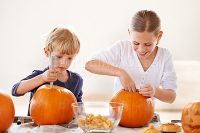 Buy stock photo Sister, brother or happy with pumpkin for halloween, celebration or decoration in kitchen of apartment or home. Family, face or smile and vegetable for preparation, holiday or creative event in house